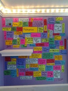 a bulletin board with lots of notes attached to it in the corner of a room