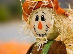 a scarecrow doll sitting on top of hay