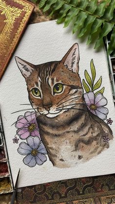 a painting of a cat with flowers on it