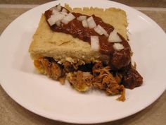 a white plate topped with a piece of food