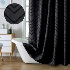 a bath tub sitting next to a window covered in black shower curtaines and rugs