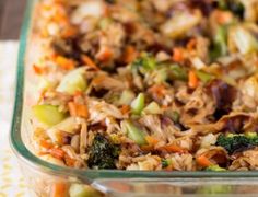 a glass casserole dish filled with rice and vegetables