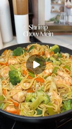 shrimp chow mein in a skillet with broccoli, carrots and noodles