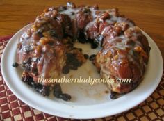 a bundt cake covered in frosting and raisins on a white plate