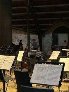 a group of musical instruments sitting next to each other in front of a stage with sheet music on it