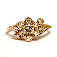 Exquisite 14 karat yellow gold cluster ring set to the center with a round-cut genuine diamond measuring approximately 4.28 millimeters in diameter and weighing an estimated .26 carats (SI1 clarity, G color), surrounded by 10 round-cut diamonds, each weighing .03 carats (VS1 clarity, G color), for a total carat weight for the ring of 0.56 carats. The ring is approximately 9.27 millimeters wide at the top and 2.29 millimeters wide at the shank. It weighs approximately 3.07 grams. It is a size 7, 14k Gold Cluster Diamond Ring With Prong Setting, Cluster Yellow Gold Diamond Ring With Prong Setting, Yellow Gold Diamond Ring With Brilliant Cut Cluster, Yellow Gold Diamond Cluster Ring For Anniversary, Yellow Gold Cluster Diamond Ring For Anniversary, Cluster Yellow Gold Ring With Rose Cut Diamonds, Yellow Gold Cluster Diamond Ring With Prong Setting, Anniversary Yellow Gold Cluster Diamond Ring, Cluster Yellow Gold Rings Stamped 14k