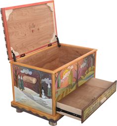 an open wooden box sitting on top of a table next to a drawer with pictures