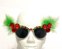 It's holiday time, so make merry with fun Christmas Sunglasses!  These child size white sunglasses have red rhinestones for holly and green feathers for leaves.  The top is covered in large red, green and clear rhinestones, and the bottom in clear rhinestones. Merry Christmas and Happy Holidays  Thank you for visiting my shop! Christmas Sunglasses, Green Feathers, Merry Christmas And Happy Holidays, White Sunglasses, Christmas Holly, Red Rhinestone, Holiday Time, Fun Christmas, Christmas Dress