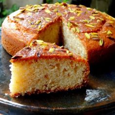 a cake that has been cut in half and is on a plate with one slice taken out