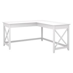 the corner desk is white and has a wooden cross - leg design on one end