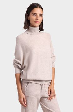 Wrap yourself in ultimate comfort and timeless style with this fabulous turtleneck! Made with the finest cashmere, this turtleneck sweater exudes elegance and luxury. The oversized fit provides a modern and relaxed silhouette, while the front pocket adds a touch of laid-back charm. Whether you're lounging at home or heading out for a casual day, this versatile piece promises to keep you cozy and effortlessly chic. Elevate your wardrobe with this cozy and stylish cashmere sweater from Minnie Rose Chic Beige Turtleneck With Funnel Neck, Chic Beige Funnel Neck Turtleneck, Oversized Cozy Cashmere Turtleneck, Cozy Oversized Cashmere Turtleneck, Chic Oversized High Neck Turtleneck, Chic Turtleneck Sweater For Loungewear, Elegant Oversized High Neck Sweater, High Neck Cashmere Sweater, Oversized Funnel Neck Turtleneck For Work