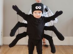 a little boy in a black spider costume