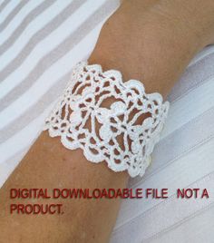 a woman wearing a white crochet bracelet on her arm