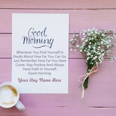 a cup of coffee sitting next to a card with the words good morning on it