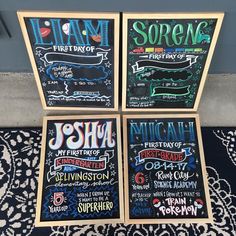 three chalkboard menus are sitting on the ground next to a door and rug