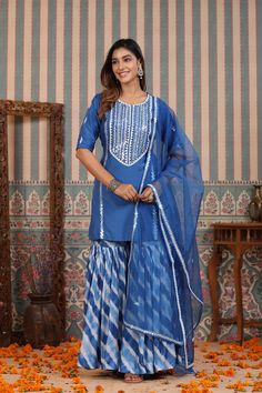 Be a vision in our Blue Tie And Dye Sharara Suit Set. Crafted in cooling blue hues of muslin featuring a unique tie and dye design, this lovely suit set is the perfect choice for summer weddings and festive occasions. The set is complete with an airy organza dupatta to add a touch of harmony to the ensemble. No. of pieces - 3 piece set. Color - Blue. Fabric - Muslin. Washing Instructions - Dry Clean. Blue Palazzo Set With Dupatta For Summer, Summer Blue Palazzo Set With Dupatta, Blue Straight Kurta Palazzo Set For Summer, Festive Indigo Sets With Dupatta, Unstitched Blue Bohemian Sets, Unstitched Bohemian Sets In Blue, Blue Bohemian Sets Unstitched, Blue Bohemian Unstitched Sets, Blue Straight Kurta Sets For Summer