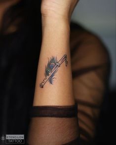 a woman with a tattoo on her wrist