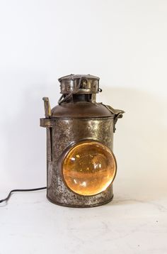 an old fashioned gas stove sitting on top of a white table next to a wall