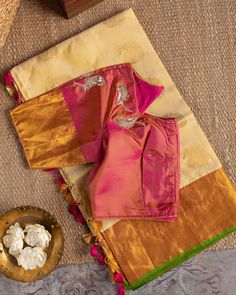 "Color : Natural Silk color and Pink. Kanchipuram silk saree in beige, flanked by golden brocade work on pink borders and pallu, paired with a pink blouse flaunting golden brocade on the sleeves and adorned with sequin-embroidered peacocks. This saree is for sure to look even more stunning when worn for any occasion.  This saree is very easy to drape and falls elegantly making it so effortless to carry around. *Fall, Pico & Tassels : Done *Condition : New Saree With Stitched Blouse with Maggam w Transitional Gold Blouse With Zari Weaving, Gold Banarasi Silk Blouse With Zari Weaving, Gold Silk Blouse With Zari Weaving, Gold Blouse With Zari Weaving In Traditional Drape, Gold Zari Weaving Blouse For Diwali, Gold Blouse With Zari Weaving For Navratri, Gold Blouse With Zari Weaving For Diwali, Gold Raw Silk Blouse With Zari Weaving, Gold Tussar Silk Blouse With Traditional Drape