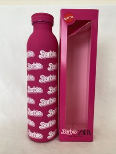 a pink bottle with the name barbie sparkle on it next to a cardboard box that says barbie sparkle