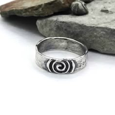 Description: SImple ring with softly textured band, center piece is a life spiral with a raised design. Available to ship Size: 4-14 I can size in whole, half or quarter sizes because we don't all fit perfectly in the whole sizes. Depending on the ring design, the design can change depending on the size. Made to order pieces - design will vary slightly from the photo, as each ring is handcrafted just for you! Specifications: Materials: Sterling silver Approximately width 6.25 mm Jewelry by Caria