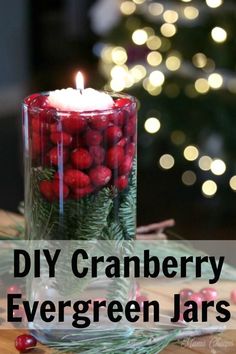 a candle that is on top of a table with berries and greenery in it