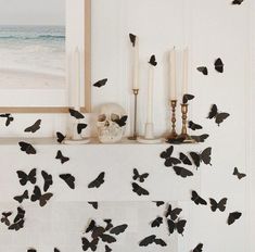 there are many black butterflies on the mantle