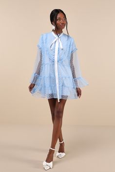 Helping you look especially sweet is what the Sister Jane Dusty Hearts Light Blue Lace Ruffled Mini Dress is an expert in! Sheer mesh fabric, with a darling heart motif throughout, shapes this swing-style, loose-fit dress that emanates whimsical vibes. Sheer long sleeves with drop shoulders and frilly flaring cuffs frame a functional partial button placket (with matching faux pearl heart-shaped buttons) and a collarless neckline, complete with a white satin necktie. Feminine ruffled trim through Flirty Summer Dresses With Sheer Sleeves, Chic Spring Mesh Dress With Ruffles, Long Sleeve Swiss Dot Summer Dress, Summer Swiss Dot Long Sleeve Dresses, Blue Swiss Dot Dress For Spring, Chic Blue Mesh Dress For Spring, Long Sleeve Swiss Dot Dresses For Spring, Spring Dresses With Sheer Sleeves And Flirty Style, Spring Mini Mesh Dress