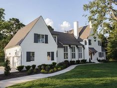 a large white house with black shutters and windows