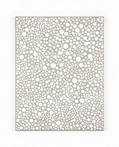 a white paper with circles and dots on the bottom, in front of a white background