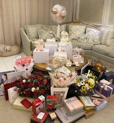 a bunch of boxes that are sitting on the floor in front of a couch and table