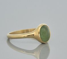 "14k solid gold Tourmaline ring. Oval cabochon green Tourmaline ring. This gold ring is a beautiful gift for your love. Classic Tourmaline ring. 14 k gold ring with beautiful green Tourmaline stone. An oval cabochon green Tourmaline stone set in a solid gold ring. This 14k solid gold ring has a beautiful presentation on the finger. The green Tourmaline stone is set vertical to the ring giving an illusion of a bigger stone. You going to love this tourmaline ring, specially if love the natural inc Green Oval Cabochon Signet Ring As Gift, Green Oval Cabochon Signet Ring For Gift, Oval Tourmaline Emerald Ring In Yellow Gold, Yellow Gold Emerald Ring, Oval Cabochon Gift, 14k Gold Oval Cabochon Emerald Ring Gift, Yellow Gold Oval Cabochon Emerald Ring, Green Signet Ring With Bezel Setting For Gift, Oval Cabochon Emerald Ring In Yellow Gold, Classic Oval Tourmaline Emerald Ring