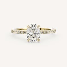 a yellow gold engagement ring with an oval cut diamond