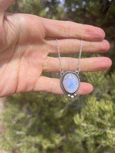 This pendant features a gorgeous blue flash Moonstone set in Sterling Silver with a beaded pattern and three larger dots in the center :) This is a beautiful flashy stone with lots of depth and an open-back design to allow lots of light to show off the crystal! The pendant comes as pictured on an 18" chain. Please let me know if you would prefer a shorter or longer length! Blue Moonstone Jewelry With Stones, Bohemian Oval Moonstone Necklace, Celestial Jewelry With Oval Natural Stones, Celestial Style Oval Jewelry With Natural Stones, Celestial Oval Jewelry With Natural Stones, Bohemian Jewelry With Round Cabochon Stone, Bohemian Jewelry With Cabochon Round Stone, Bohemian Jewelry With Cabochon Stones, Oval Blue Moonstone Necklace