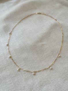 "This dainty chain necklace is lovely for both special occasions or as an every day peice! Each tiny Pearl dangles from the shiny gold paperclip chain making it a simple yet eye catching piece! Create a stunning matching set by adding the Tiny Pearl Drop Bracelet! *14K Gold Filled or 925 Sterling Silver paperclip chain & dainty spring clasp * Adjustable 16\" - 18\" * 3mm natural tiny Pearls * 14/20 gf or 925 stamp for authenticity * Made with 100% hypoallergenic materials 🤍 ✨ See all Pearl Jewe Dainty Chain Necklace, Bridal Pearl Necklace, Pearl Drop Necklace, Pearl Chain Necklace, Freshwater Pearl Necklace, Vermeil Jewelry, Fall Jewelry, Necklace Dainty, Choker Necklaces