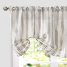 an open window with white and grey striped curtains