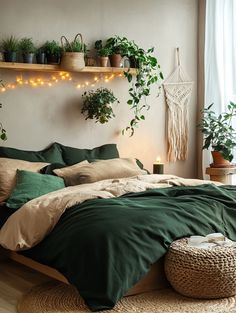 a bed with green sheets and pillows in a room filled with potted plants on the wall