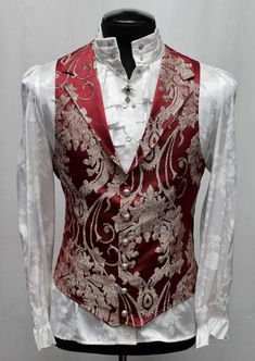 Note: These vests are very fitted. Check the size measurements below very carefully to find the size that will fit you best. A Victorian gentleman's vest with class. Great for formal occasions, can be worn under a suit jacket or by itself. Made in rich red satin brocade fabric with a woven ivory floral design on it. With black satin lining inside and on the back. This vest has a very flattering tapered fit and ties in back with satin belting so it can be made tighter in the waist. Fastens in fro Red Vest Outfit Men, Fitted Sleeveless Vest For Wedding, Fitted Sleeveless Vest For Semi-formal Occasions, Classic Fitted Party Vest, Formal Fitted Sleeveless Vest, Fitted Sleeveless Suit With Vest, Elegant Fitted Suit With Vest, Elegant Fitted Three-piece Suit With Vest, Red Fitted Vest For Party