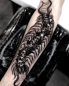 a black and white tattoo with skulls on it