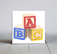 three blocks with letters on them sitting on a table