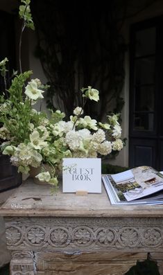 white flowers are sitting on top of a table