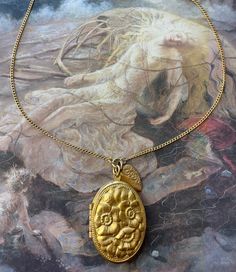 "What a stunning solid brass awesome detailed bold raised relief Floral Locket with Heart Charm. Great quality. Nice weight piece. These designs are from stampings tooled at the turn of the last century. Stunning! 14\" in length  Locket 1 1/2\" in size  Great nostalgic piece.  If you buy more than 5 items in the store, shipping is FREE." Heirloom Gold Brass Locket Necklace, Gold Heirloom Brass Locket Necklace, Gold Medallion Necklace With Antique Finish, Handmade Brass Gold Locket Necklace, Handmade Gold Brass Locket Necklace, Collectible Gold Necklace With Intricate Design, Ornate Brass Necklace With Antique Finish, Ornate Gold Brass Locket Necklace, Ornate Gold Locket Necklace In Brass