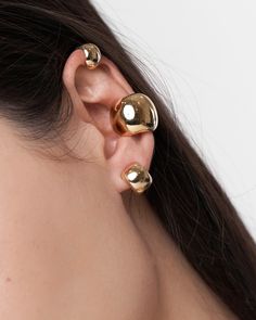 Show off a cool and chic modern look with this lux Leda Ear Cuff Set! Make a statement by wear them stacked on one ear or on opposite ears. The design hugs your ear and creates a floating effect. The Ear Cuff Set is made of a thick and solid mold. To wear it, slide the opening of the ear cuff through the thinnest part of your ear, and position it where it fits snug. For the larger Earcuff pushing once you slide it through the thinnest part of the ear, hook it hooks over the helix and let it rest Modern Gold Ear Cuff For Party, Chic Adjustable Gold Ear Cuff, Luxury Modern Ear Cuff, Yellow Gold Brass Ear Cuff For Pierced Ears, Modern Clip-on Ear Cuff, Modern Gold-plated Ear Cuff, Modern Tarnish-resistant Yellow Gold Ear Cuff, Elegant Gold-plated Hypoallergenic Ear Cuff, Ear Parts