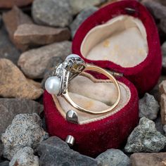 This beautiful circa 1900 ring features a pierced platinum gallery that is bordered with milgrain edging and finished with a 14K yellow gold shank. The ring is centered with one (1), bezel set, old mine cut diamond and bordered with eight (8), bead set, old European cut diamonds and two (2), post set, natural pearls. The ring measures 16.0mm at the top, rises 5.8mm above the finger, tapering to 1.5mm wide and 1.2mm thick at the base of the shank. This ring is currently a size 6.25. Luxury Antique Diamond Pearl Ring, Luxury Antique Cabochon Pearl Ring, Luxury Pearl Ring With Bezel Setting, Diamond Pearl Ring, Old Mine Cut Diamond, Pearl And Diamond Ring, Bead Set, November Birthstone, European Cut Diamonds