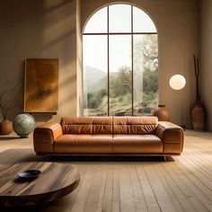 a leather couch sitting in front of a large window