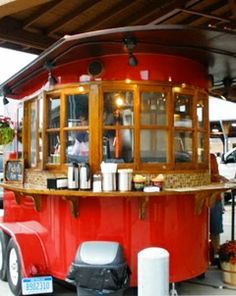 an old fashioned food truck is parked on the side of the road