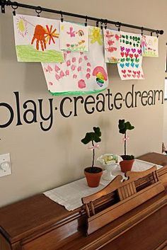 a piano in front of a play create dream sign