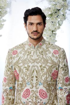 This sherwani set features all over multi-coloured aari embroidery with hand highlighting on a cream raw silk base. It is paired with a matching silk kurta and dhoti pants.From Seema Gujral's Tuscan Summer collection. DELIVERY TIMEPlease allow 4 months for your outfit to arrive.FABRIC DETAILSRaw SilkProfessional cleaning only. Festive Designer Sherwani With Floral Embroidery, Festive Raw Silk Bandhgala With Floral Embroidery, Bollywood Bandhgala With Floral Embroidery For Transitional Season, Bollywood Style Floral Embroidered Sherwani For Eid, Designer Transitional Sherwani With Floral Embroidery, Traditional Silk Nehru Jacket For Reception, Diwali Sherwani With Floral Embroidery In Raw Silk, Eid Bollywood Sherwani With Floral Embroidery, Festive Bandhgala With Floral Embroidery In Raw Silk