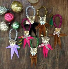 several ornaments are laid out on a wooden table with pineapples and other holiday decorations