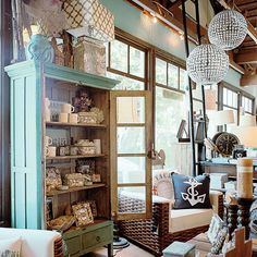 a living room filled with furniture and lots of lights hanging from it's ceiling